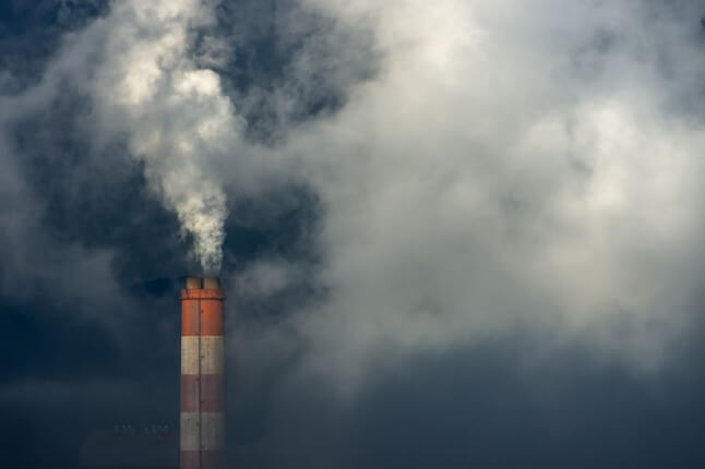 smoke stack billows dark smoke 