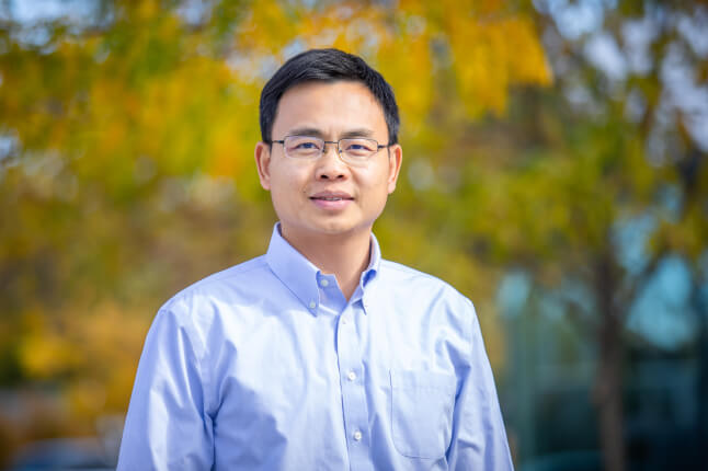 image of person outside smiling in light blue button down shirt 