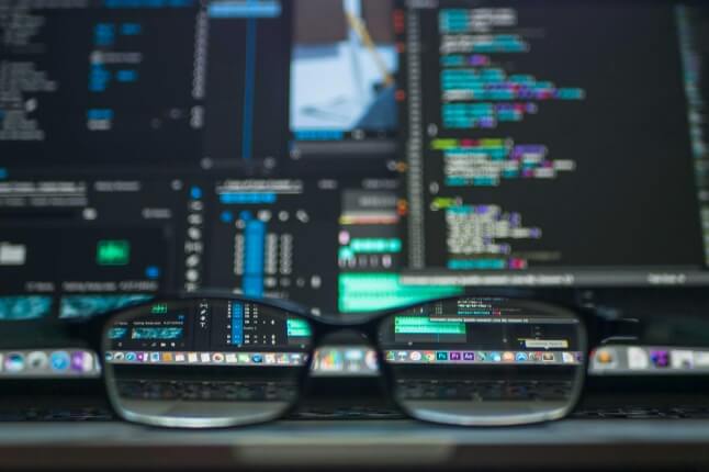 Glasses in front of computer screens