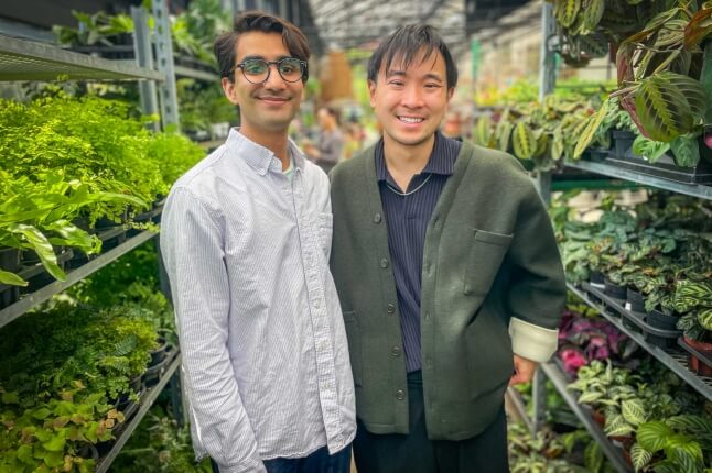 Harvard SEAS GSD students Akhil Dayal and Darren Chin in front of rows of potted plants