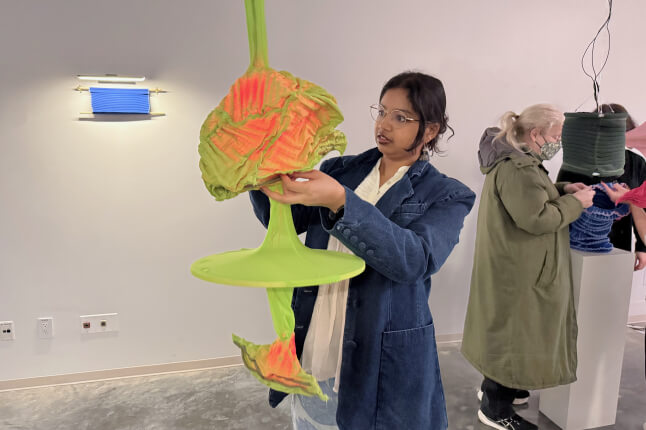 Harvard SEAS student Kausalya Mahadevan with an illuminated fabric