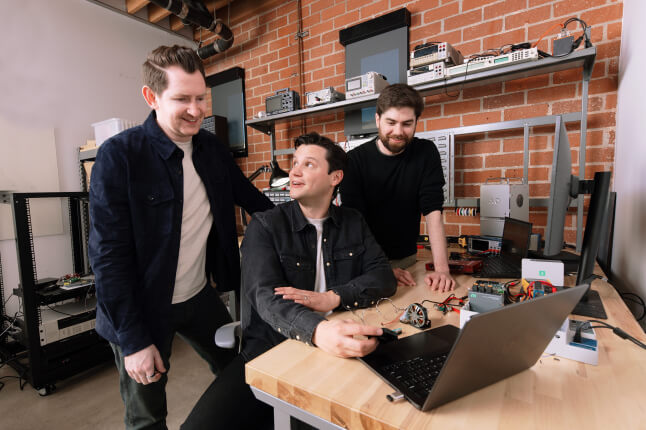 Harvard SEAS HBS alum Bryce Strauss with start-up co-founders Cameron McCord and Jason Hoch sitting at a laptop