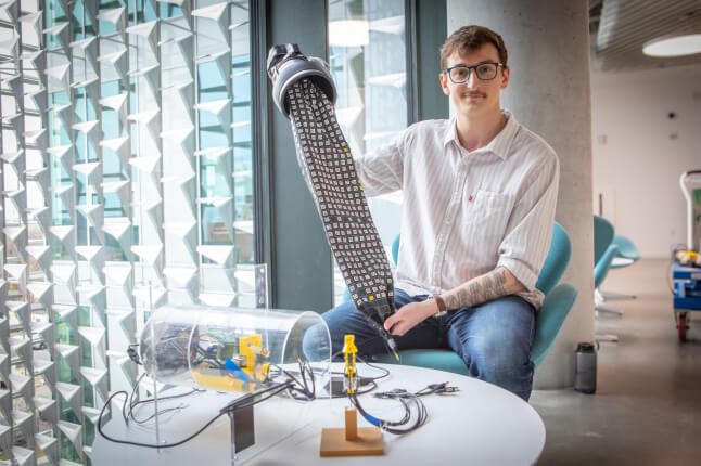 Harvard SEAS student Viktor Bokisch holding a soft-materials robot and scanning sensors