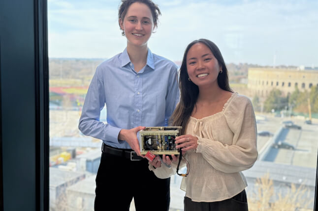 Harvard SEAS students Isabel Laguarda and Jennifer Nguyen holding their senior capstone project