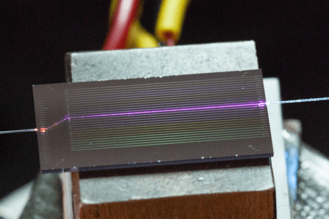 Camera image of the sidewall-poled lithium niobate chip during UV generation.