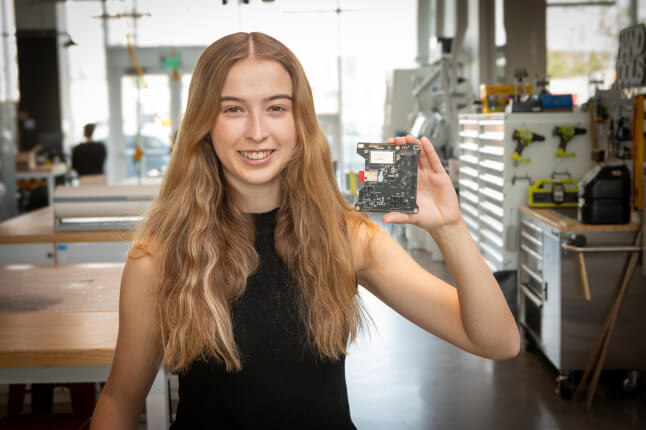 Harvard SEAS student Madison Davis holding a circuit board
