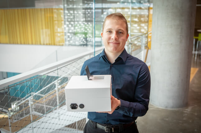 Harvard SEAS student Konstantinos Maliaris holding a white box