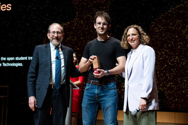 Harvard SEAS student Yann Calvó López on a stage with Harvard President Alan M. Garber and Harvard Innovation Labs Executive Director Jill Kravetz