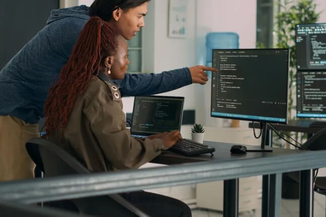 Two people working on computer