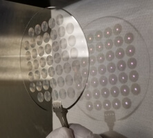 A picture of a group of metalense on a piece of glass with light streaming through