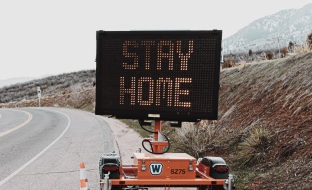 road sign reading stay home