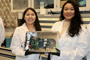 Zabari-Obyoni Bell and Tionna Tapaha display their device