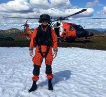 Andrew Lund in front of a helicopter