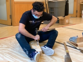 David Andrade chisels a block of wood
