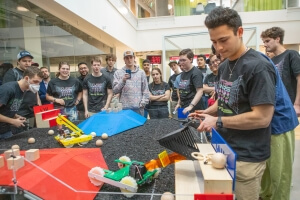 Gabe Twohig, right, drives his robot to victory in the finals of the &quot;Turf Wars&quot; competition