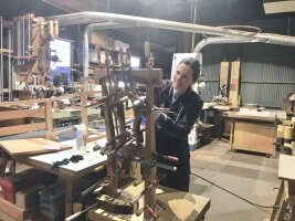 Taimi Barty, A.B. '94, working on a piece of wooden furniture in her studio