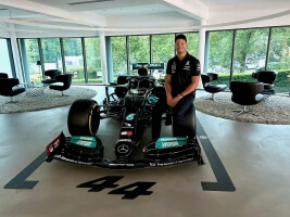 Harvard SEAS mechanical engineering concentrator Brice Austin standing beside an F1 race car