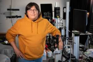 SEAS Ph.D. student Robinson Tom next to several pieces of bioengineering laboratory equipment