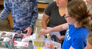 students cooking brownies in a high school lab