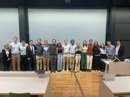 Harvard students standing in front of a projection screen