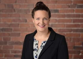 Image of Harvard graduate Emily Parfit in front of a brick wall