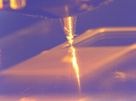 close-up of 3D printer nozzle writing square spirals