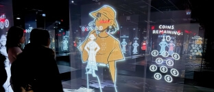 A group of Harvard students looking at projected graphics in a mirrored room