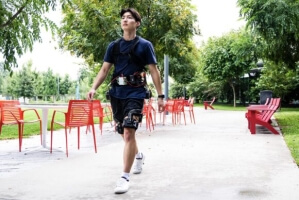 Man walks wearing a robotic exosuit