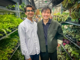 Harvard SEAS GSD students Akhil Dayal and Darren Chin in front of rows of potted plants