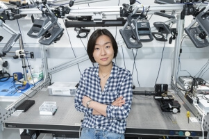 Harvard SEAS student Soy Choi in front of an engineering workbench