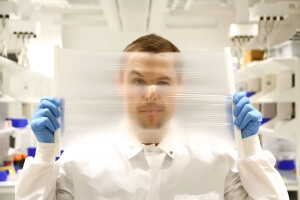 researcher holding up a clear screen