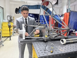 Harvard SEAS student Rayhaan Saaim attaching an automotive suspension system to a formula racecar chassis