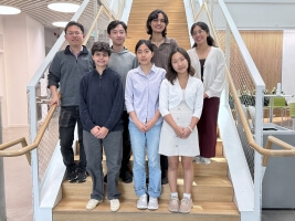 Harvard SEAS student Yi Zhu and staff member Lizette Ortega, along with five high school and undergraduate students standing on a staircase