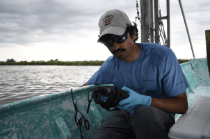 Harvard SEAS student Umar Azad in a boat on the water