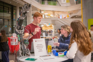 Harvard SEAS students at a table for the Harvard Undergraduate Robotics Club
