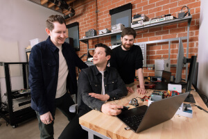 Harvard SEAS HBS alum Bryce Strauss with start-up co-founders Cameron McCord and Jason Hoch sitting at a laptop