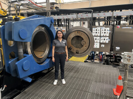 Harvard SEAS alum Nancy De Haro Castañón, S.B. ‘13, in front of the Sandia National Laboratories Explosive Destruction System