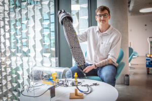 Harvard SEAS student Viktor Bokisch holding a soft-materials robot and scanning sensors