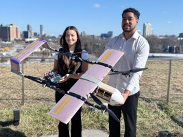 Harvard SEAS Kuma McCraw and Mikaya Parente holding a fixed-wing drone