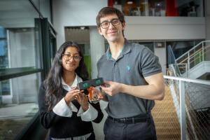 Harvard SEAS students Elsa Oreen and Daniel Kocot holding a pair of smart glasses