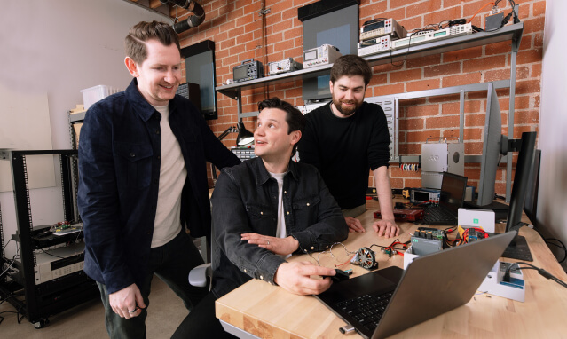 Harvard SEAS HBS alum Bryce Strauss with start-up co-founders Cameron McCord and Jason Hoch sitting at a laptop